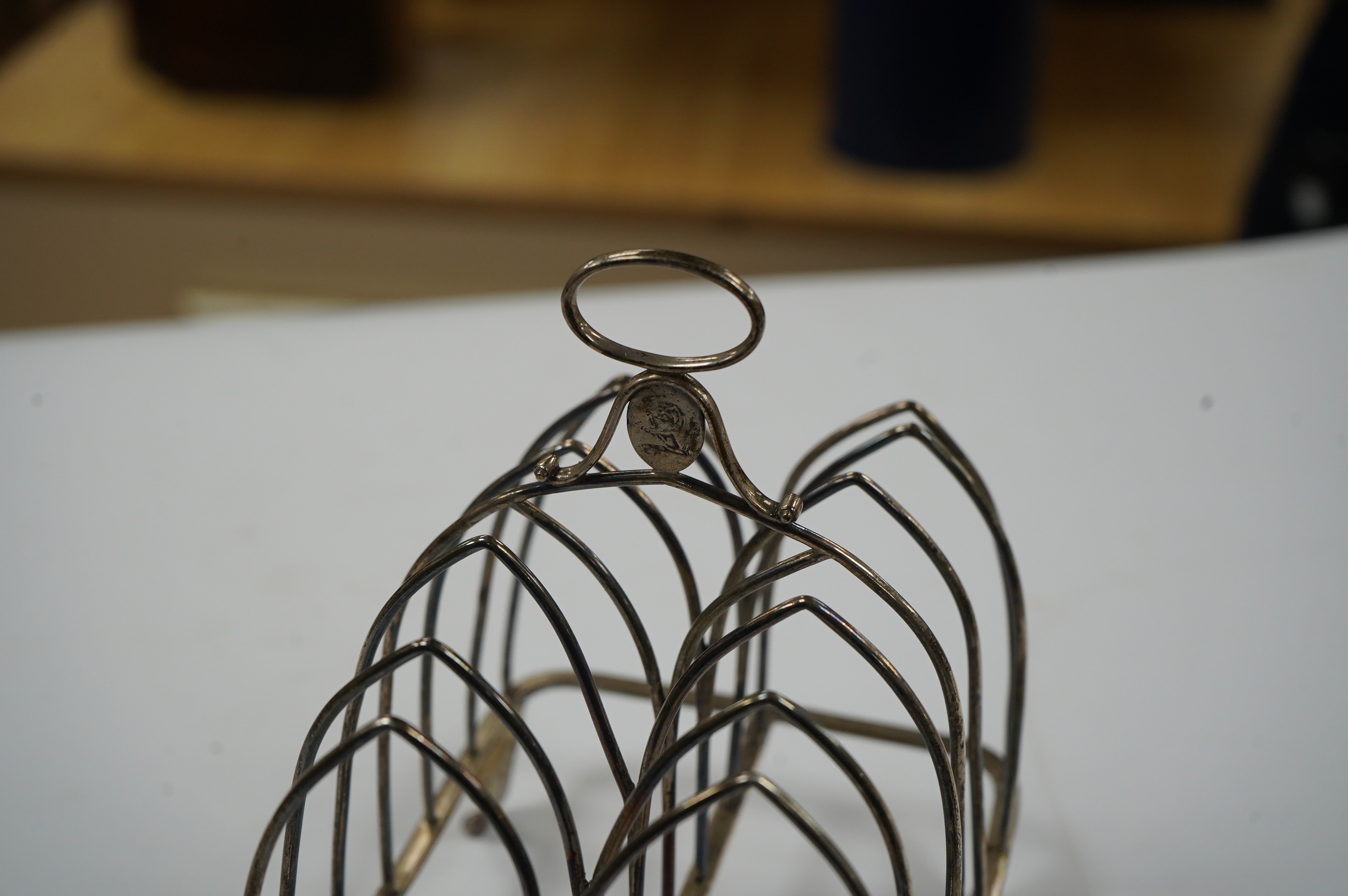 A George III silver seven bar toast rack, by Henry Chawner, London, 1795, with ring handle, length 14.7cm, 5.8oz. Condition - fair